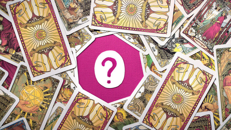 consulta-tarot - El templo de Gala - El templo de Gala Una mesa fuxia con un papel con una interrogación dibujada en el centro en color fuxia, alrededor hay cartas del tarot con ilustraciones de árboles, estrellas, lunas, personas, mujeres jóvenes con corona naturales de flores, ramas y hojas - El Templo de Gala -Tarot